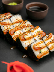 Unagi maki with an eel on a black background