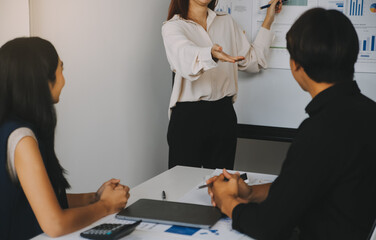 Financial analysts analyze business financial reports on a digital tablet planning investment project during a discussion at a meeting of corporate showing the results of their successful teamwork.