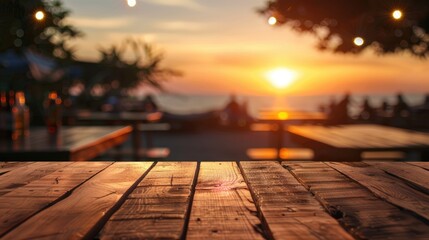 Blurred sunset background with empty wooden table and bar counter.