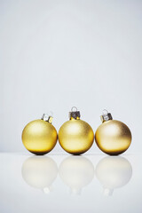 Golden Christmas balls on white background