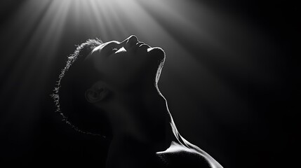 Low-key lighting photograph of a figure in the shadows, using black to convey power and dominance 