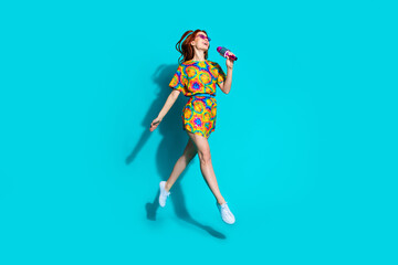 Full size photo of pretty young girl singing karaoke mic sunglass jump walk wear colorful outfit...