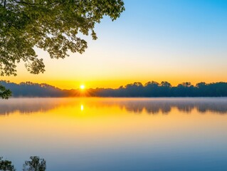 Obraz premium Golden sunrise reflecting on calm waters in a serene lakeside landscape at dawn