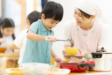 給食をよそう4歳の男の子