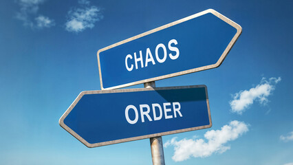Fototapeta premium Two directional road signs with chaos and order options, symbolic crossroads under a clear blue sky, decision-making concept, choosing between disorder and structure represented by signpost choice