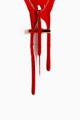 cross in blood with streaks and drops of blood on a light background