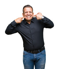 Fototapeta premium Handsome middle age arab business man over isolated background smiling confident showing and pointing with fingers teeth and mouth. Health concept.