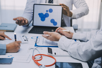 Meeting, tablet and team of doctors with collaboration for healthcare talk and telehealth app in office. Surgeon group, tech and medical discussion with website for hospital funding or sponsorship