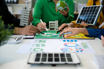 colleagues discussing data working and tablet, laptop with on Construction Site project, green energy and solar panel concept.