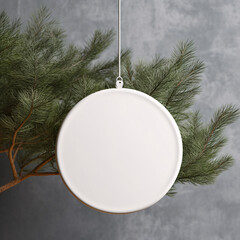 White blank round ceramic christmas ornament mockup. Hanging ceramic christmas element with Christmas tree branches concrete wall background.