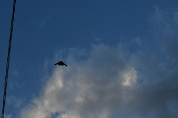 Military Bomber in a Cloudy Blue Sky