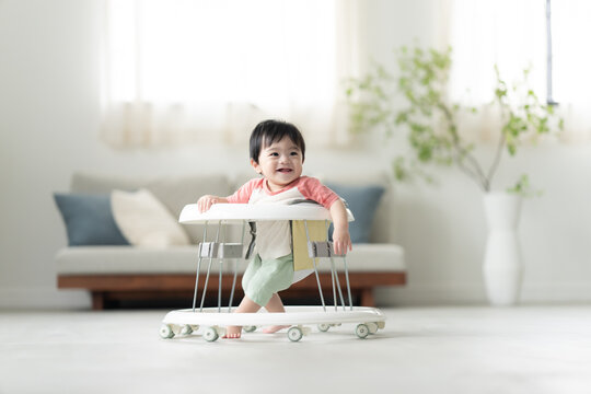 歩行器を使って歩く生後10ヶ月の男の子