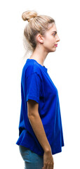 Young beautiful blonde and blue eyes woman wearing blue t-shirt over isolated background looking to...