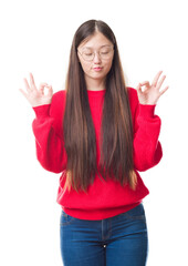 Young Chinese woman over isolated background wearing glasses relax and smiling with eyes closed doing meditation gesture with fingers. Yoga concept.