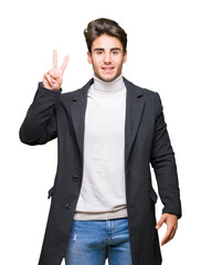 Young elegant man wearing winter coat over isolated background showing and pointing up with fingers number two while smiling confident and happy.