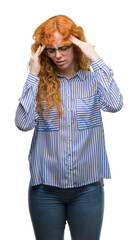 Young redhead bussines woman with hand on head for pain in head because stress. Suffering migraine.