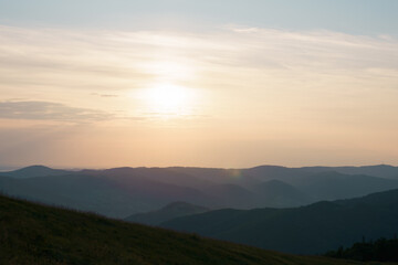 View of the dawn and the sky with the sun shining on the mountains. Image for your design and space for your text. The concept of hiking, outdoor recreation, biodiversity conservation