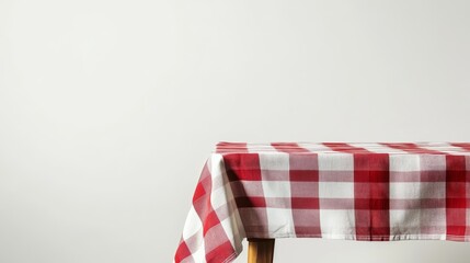 A checkered tablecloth is draped over a wooden table, shown against a white background