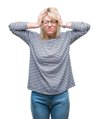 Young beautiful blonde woman wearing glasses over isolated background suffering from headache desperate and stressed because pain and migraine. Hands on head.