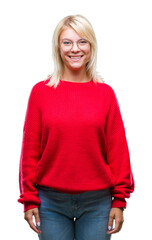 Young beautiful blonde woman wearing sweater and glasses over isolated background with a happy and cool smile on face. Lucky person.