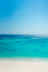 Beautiful tropical beach. Sea waves white sand, turquoise ocean against sunny blue sky clouds happy summer day. summer background and summer holiday concept.