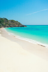 Tropical beach, turquoise sea water, ocean wave, white sand, green palms, sun blue sky, white clouds, beautiful seascape, summer background and summer holiday concept.