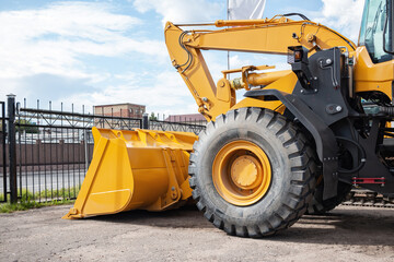 Yellow tractor at the back. Construction equipment.