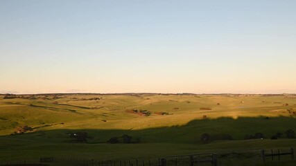 sunset over rolling hills on a farm and ranch in spring. flying over a sustainable farm, storing soil carbon. storing carbon and Carbon sequestration 