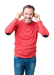 Fototapeta premium Handsome middle age hoary senior man wearing winter sweater over isolated background Smiling pulling ears with fingers, funny gesture. Audition problem