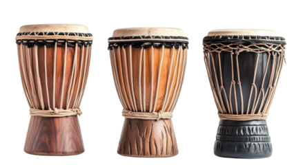 Three colorful wooden African djembe drums, isolated on a black background, emit a sense of rhythm and cultural vibrancy. 