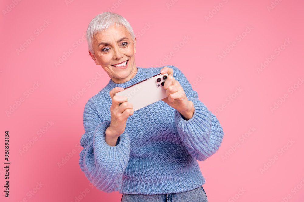 Canvas Prints Photo portrait of pretty retired female play mobile game wear trendy blue knitwear outfit isolated on pink color background