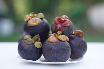 Fresh mangosteens. Concept, Seasonal tropical fruit. Mangosteen is named as the queen of tropical...
