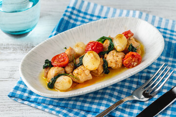 Appetizer with shrimps, onions and tomatoes on a white porcelain plate