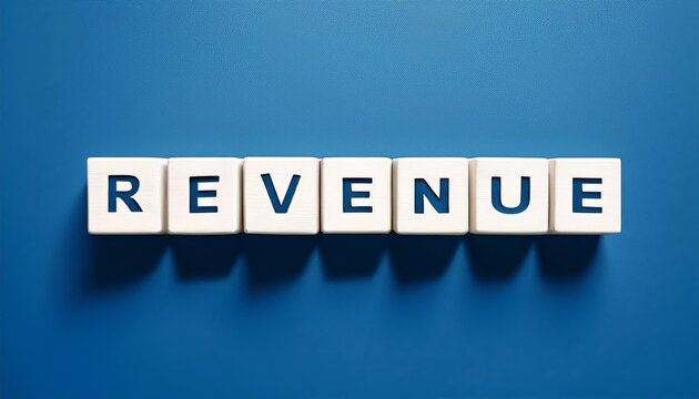 A close-up view of letter blocks spelling the word 'Revenue' on a blue background, symbolizing financial growth and success.