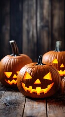 Three pumpkins with glowing eyes sit on a wooden table