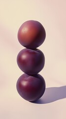 Fototapeta premium A stack of plum fruit balancing on top with solid background
