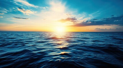 Obraz premium A picturesque ocean sunset, showcasing vibrant colors and tranquil waves reflecting the golden sun.