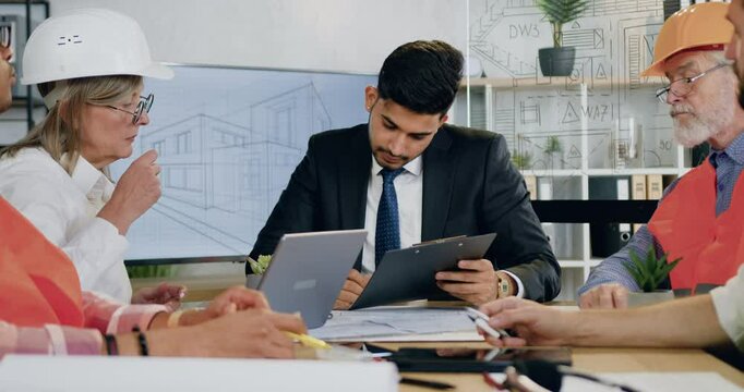 Man main engineer signing construction report from female architect during joint meeting about future building
