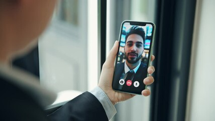 Business person using smartphone to make video call to talk to trader or his marketing agent to order offer stock in stock market - Powered by Adobe