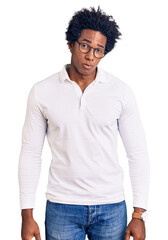 Handsome african american man with afro hair wearing casual clothes and glasses skeptic and nervous, frowning upset because of problem. negative person.