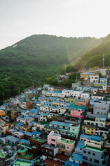 Colorful hillside homes of Busan basking in warm sunlight during a serene late afternoon