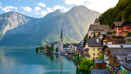 Fototapeta premium Charming lakeside village of Hallstatt, Austria basking in golden sunlight on a serene afternoon