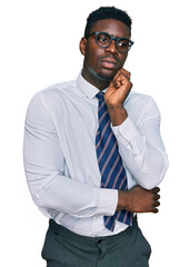 Handsome business black man wearing white shirt and tie serious face thinking about question with hand on chin, thoughtful about confusing idea