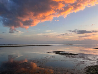 Beautiful sunset on ocean beach. Sky is reflecting at water. Philippines, Bohol