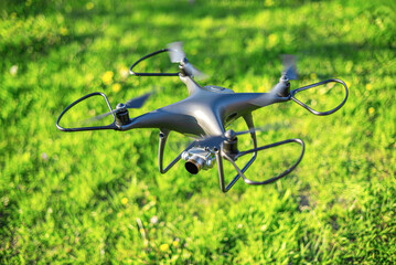 Drone quadcopter on the background of green grass. Top view.