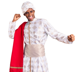 African handsome man wearing tradition sherwani saree clothes dancing happy and cheerful, smiling moving casual and confident listening to music