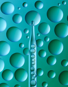 Pipette serum oil sample swatch texture dropper isolated on blue green background. Skin care cosmetic Hyaluronic acid retinol science lab product