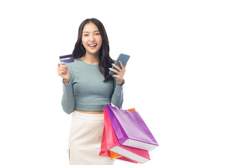 Cheerful young woman hold credit card and shopping bags, showcasing a positive shopping experience. Creates modern and fresh atmosphere, perfect for illustrating ecommerce or retail concepts.