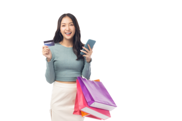 Cheerful young woman hold credit card and shopping bags, showcasing a positive shopping experience. Creates modern and fresh atmosphere, perfect for illustrating ecommerce or retail concepts.