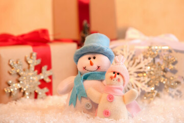 Funny snowman figures and gifts on artificial snow